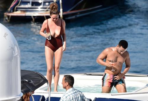 Chrissy Teigen Pictures Chrissy Teigen sexy cleavage and ass in a swimsuit with her husband John Legend seen by paparazzi.