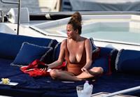 Chrissy Teigen sexy cleavage and ass in a swimsuit with her husband John Legend seen by paparazzi.
