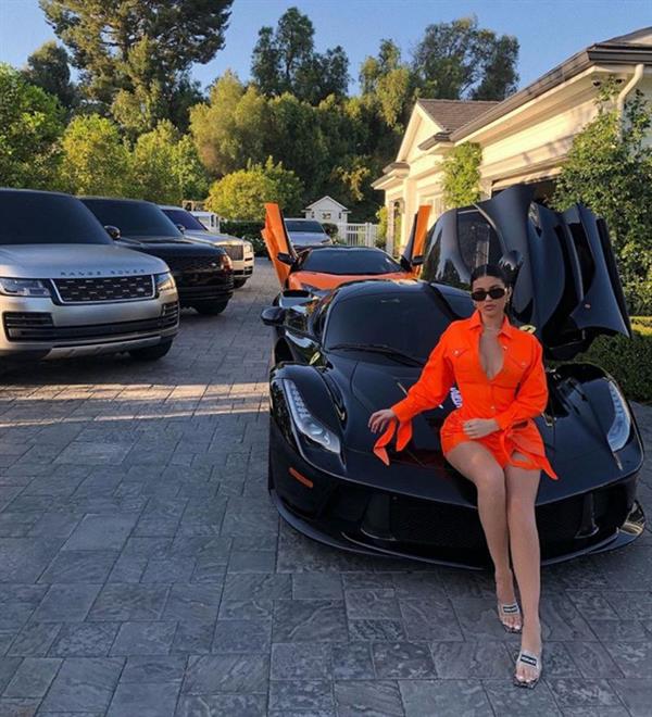 Kylie Jenner sexy and rich showing some nice cleavage and showing off her cars.












