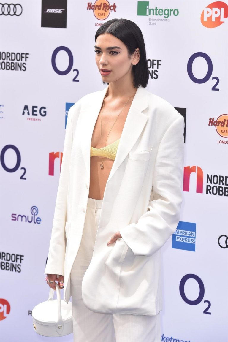 Dua Lipa looking hot in a sexy revealing top seen by paparazzi.





