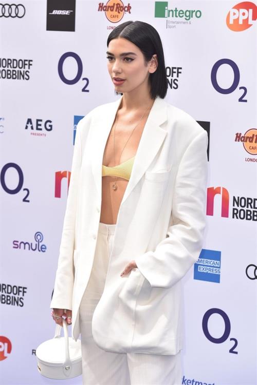 Dua Lipa looking hot in a sexy revealing top seen by paparazzi.





