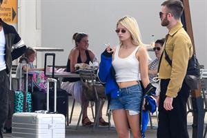 Lottie Moss braless boobs in a white top seen by paparazzi at the airport.

