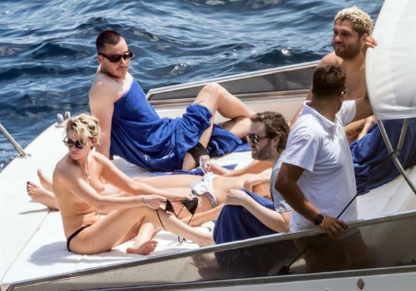 Kristen Stewart nude boobs caught topless by paparazzi tanning on a boat.
