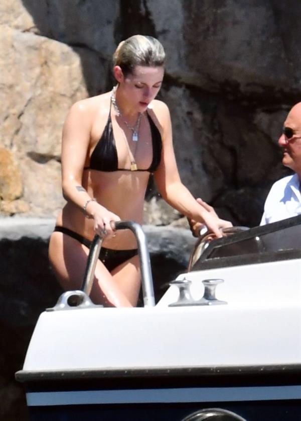 Kristen Stewart nude boobs caught topless by paparazzi tanning on a boat.
