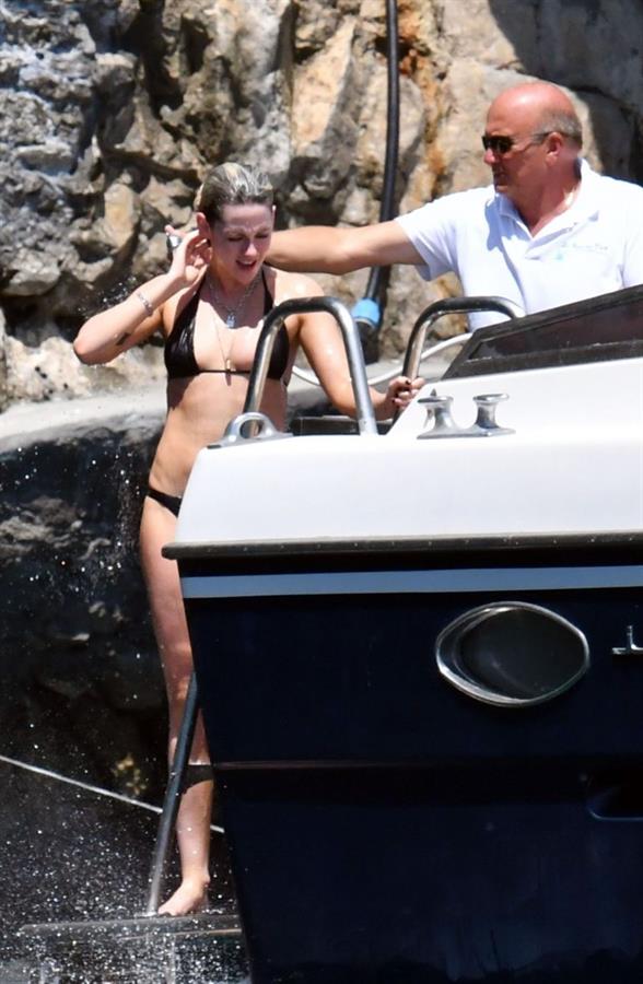 Kristen Stewart nude boobs caught topless by paparazzi tanning on a boat.
