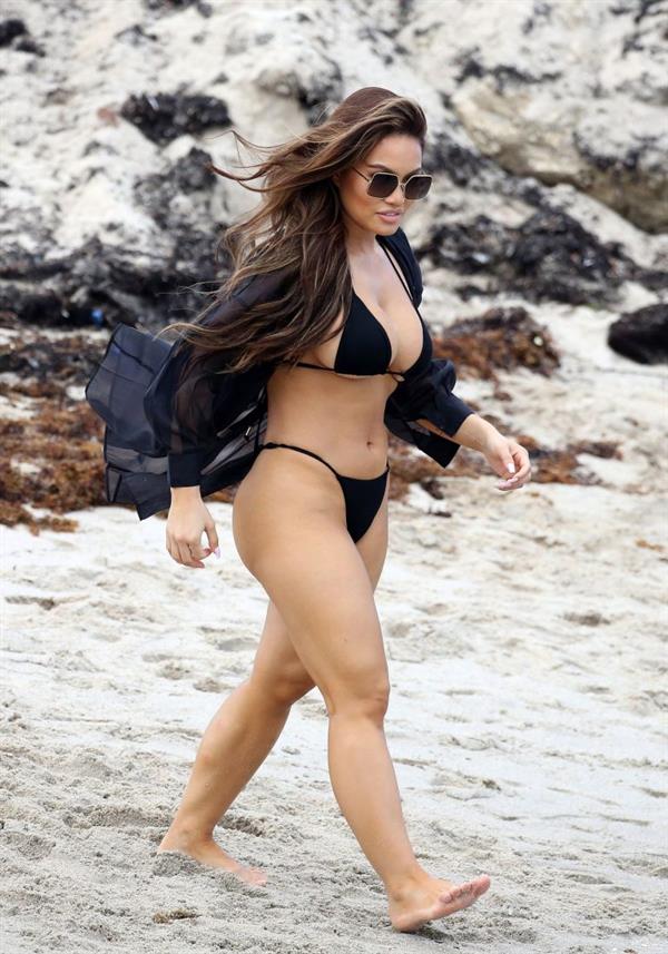 Daphne Joy sexy ass and boobs in a thong bikini at the beach seen by paparazzi showing nice cleavage and booty.
