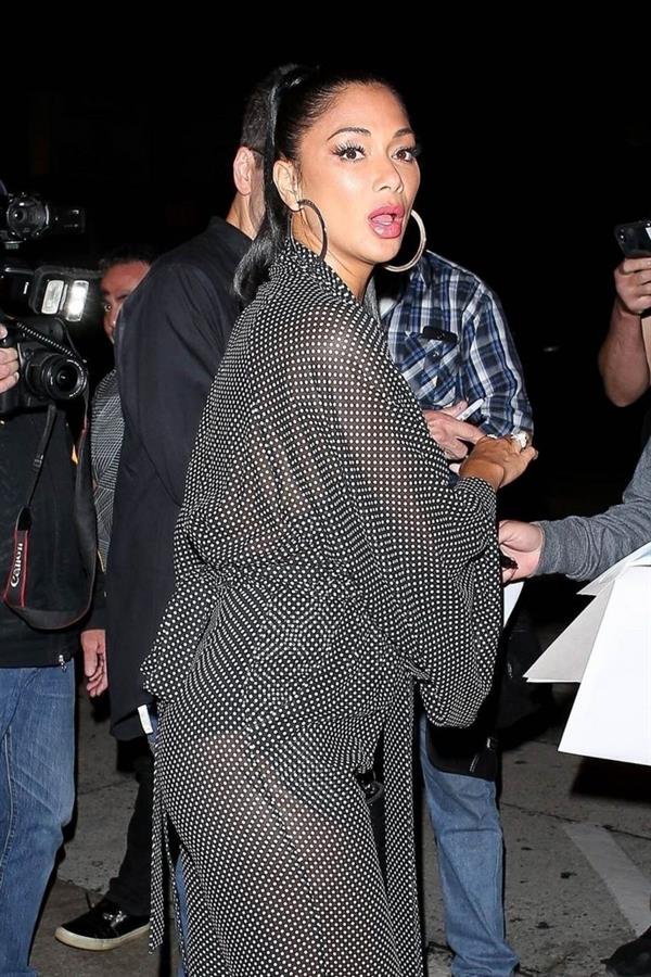 Nicole Scherzinger sexy in a see through outfit showing her braless boobs and ass seen by paparazzi.
