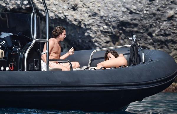 Madalina Diana Ghenea sexy ass and cleavage in a thong bikini seen by paparazzi.


