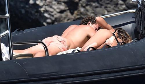 Mădălina Diana Ghenea Bikini Pictures Madalina Diana Ghenea sexy ass and cleavage in a thong bikini seen by paparazzi.