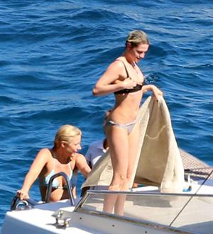 Kristen Stewart and Stella Maxwell sexy lesbians making out on a boat in bikinis seen by paparazzi.










