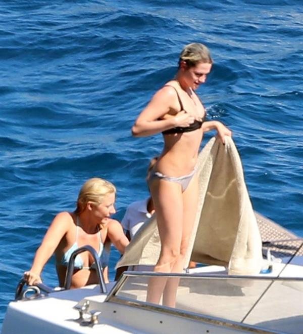 Kristen Stewart and Stella Maxwell sexy lesbians making out on a boat in bikinis seen by paparazzi.










