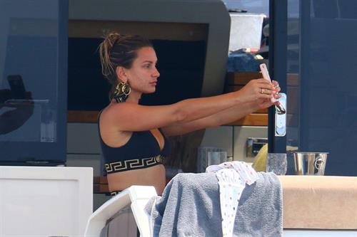 Sam Faiers Bikini Pictures Sam Faiers sexy in a black versace bikini seen by paparazzi showing nice cleavage.