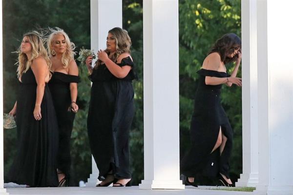 Selena Gomez sexy in a black dress for her cousins wedding showing nice cleavage seen by paparazzi.























