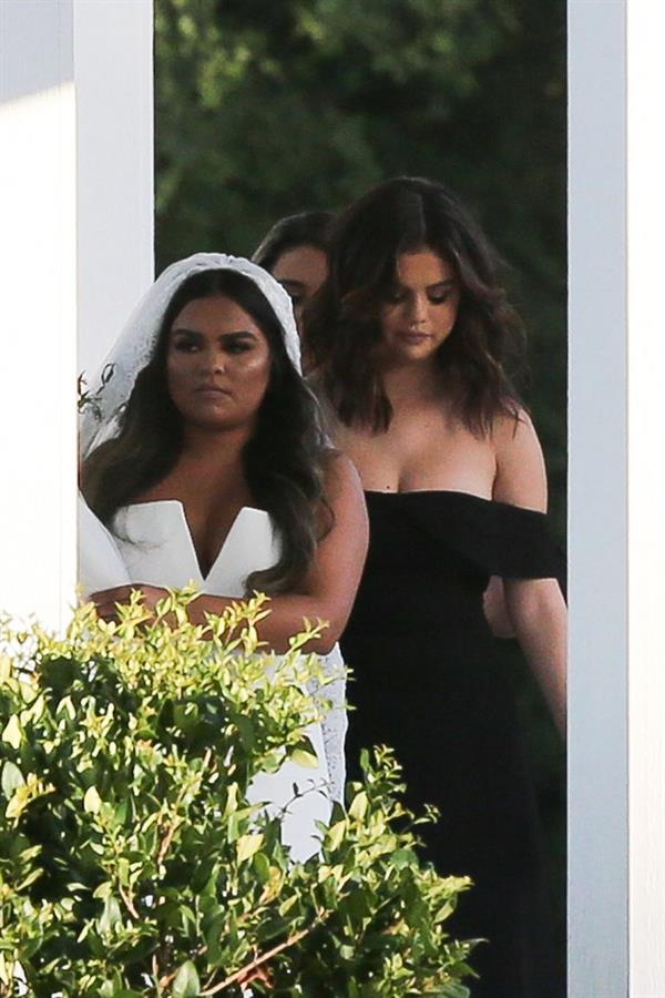 Selena Gomez sexy in a black dress for her cousins wedding showing nice cleavage seen by paparazzi.























