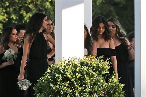 Selena Gomez Pictures Selena Gomez sexy in a black dress for her cousins wedding showing nice cleavage seen by paparazzi.