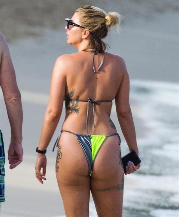 Olivia Buckland sexy in a bikini at the beach seen by paparazzi showing nice cleavage.



