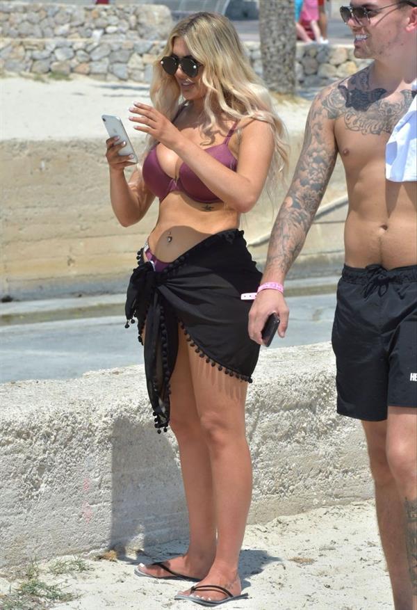 Chloe Ferry big boobs showing nice cleavage seen by paparazzi in a sexy bikini.








