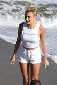 Hailey Bieber braless nipples pokies in a white top at the beach seen by paparazzi during a photo shoot.



















