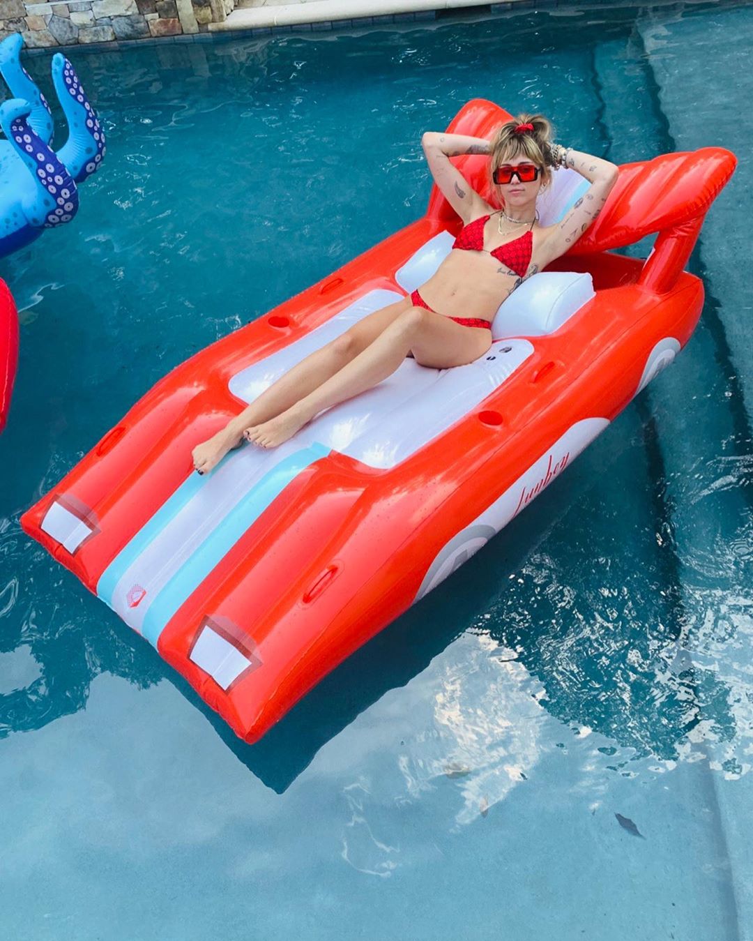 Miley Cyrus Bikini Pictures Miley Cyrus sexy in a red bikini in the pool.