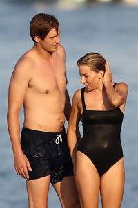 Sienna Miller nip slip wardrobe malfunction boobs popping out of her swimsuit caught by paparazzi.







