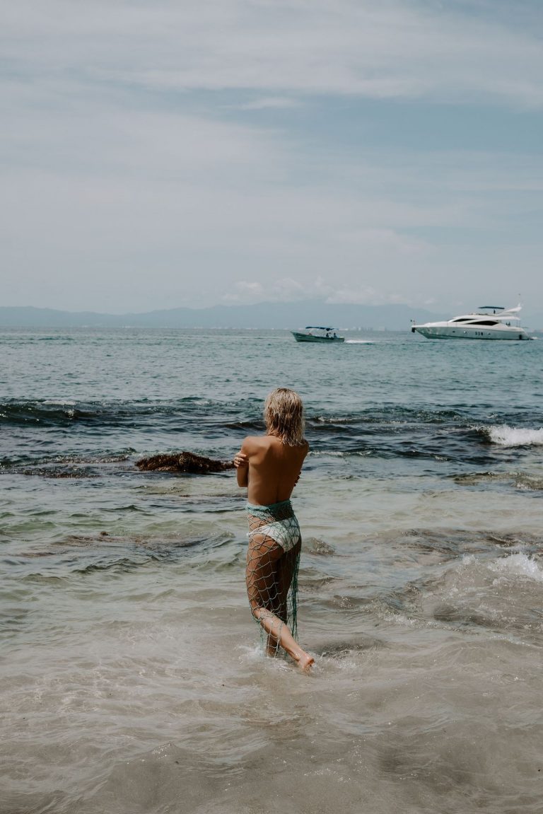 Kristin Cavallari Bikini Pictures Kristin Cavallari topless seen by paparazzi at the beach covering her nude boobs with her arms.