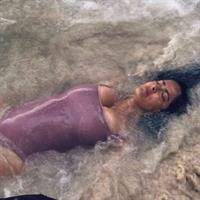 Salma Hayek big boobs showing nice cleavage wet in a swimsuit laying on the beach.

























