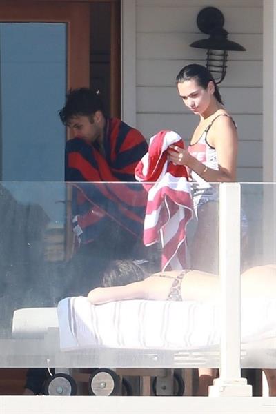 Dua Lipa sexy ass and cleavage in a swimsuit at the beach seen with her boyfriend by paparazzi.













