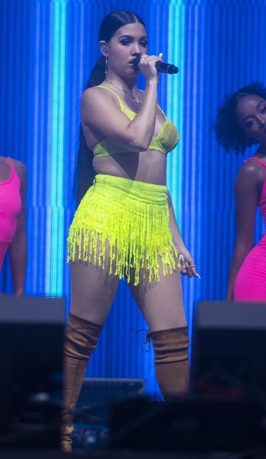 Mabel performing on stage singing in just a bra top showing off her boobs.
















