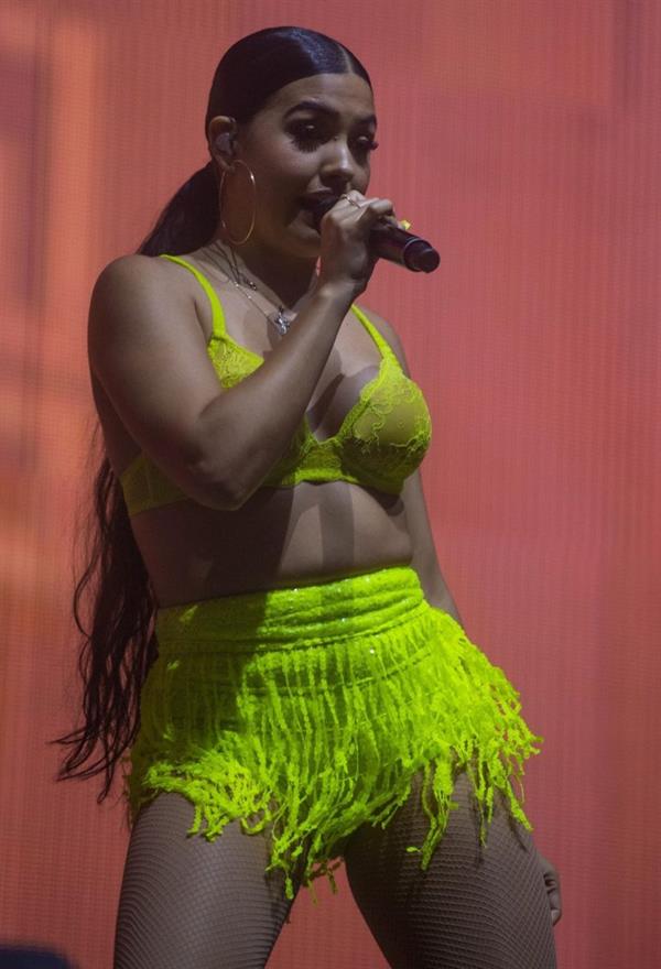 Mabel performing on stage singing in just a bra top showing off her boobs.
















