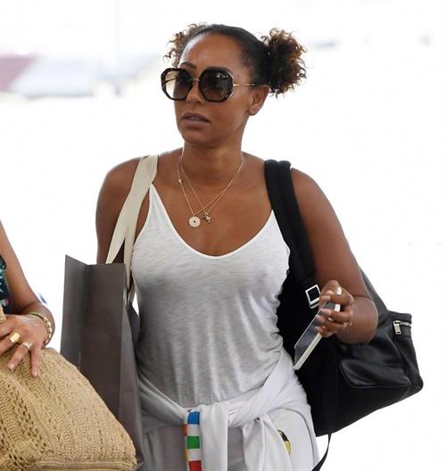 Melanie Brown Pictures Mel B braless boobs in a see through white top showing off her tits seen by paparazzi at the airport.
