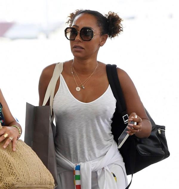 Mel B braless boobs in a see through white top showing off her tits seen by paparazzi at the airport.






