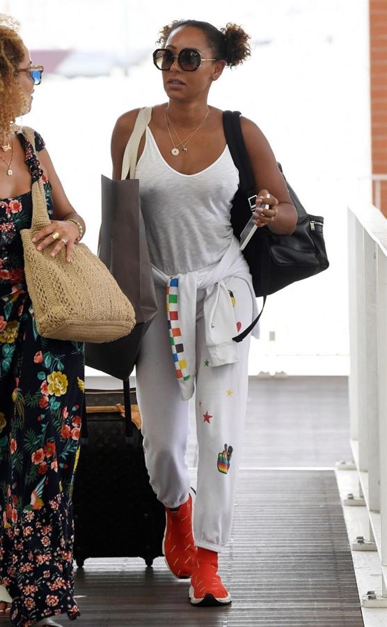Mel B braless boobs in a see through white top showing off her tits seen by paparazzi at the airport.






