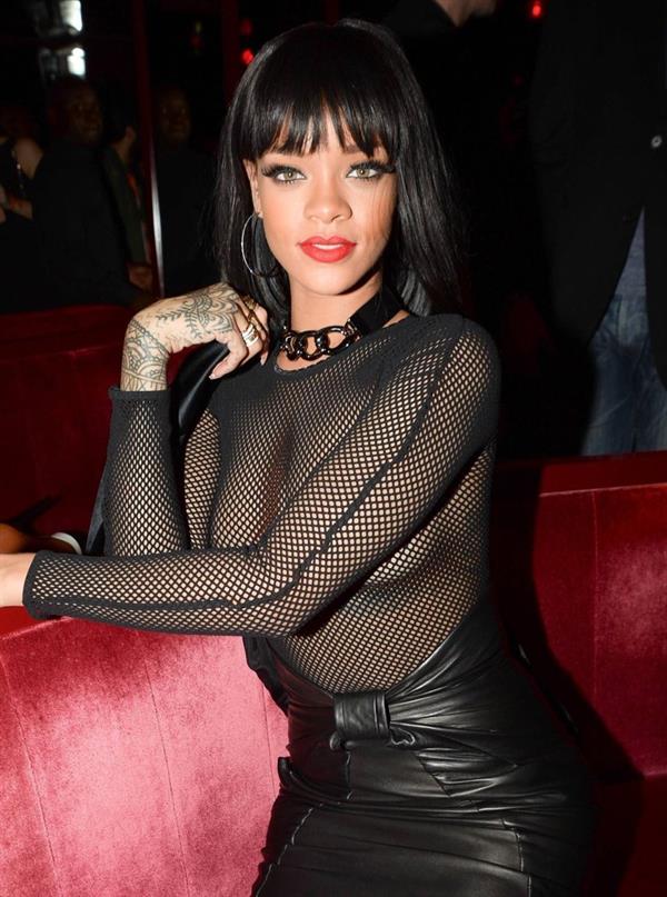 Rihanna braless boobs in a see through fishnet top showing off her tits and pierced nipple.




