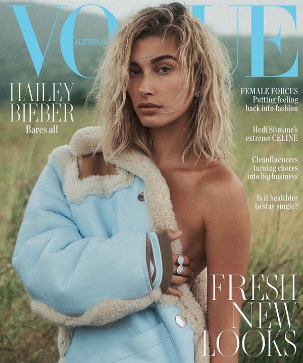 Hailey Bieber topless new photo shoot for Vogue covering her nude boobs.

