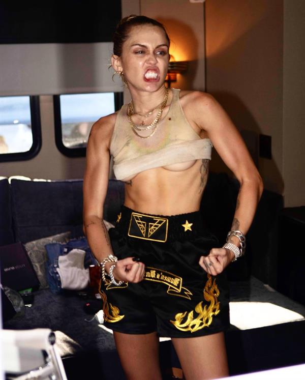 Miley Cyrus braless boobs and flexing showing nice underboob.



