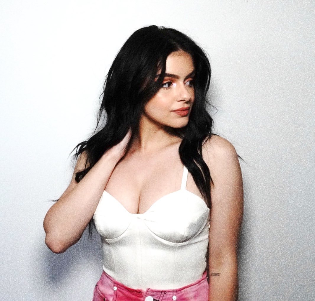 Ariel Winter Pictures Ariel Winter sexy in a white top showing nice cleavage with her big tits.