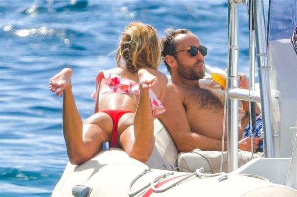 Alizée Thevenet sexy ass in a red bikini showing off her perfect model body seen with James Middleton at the beach by paparazzi.