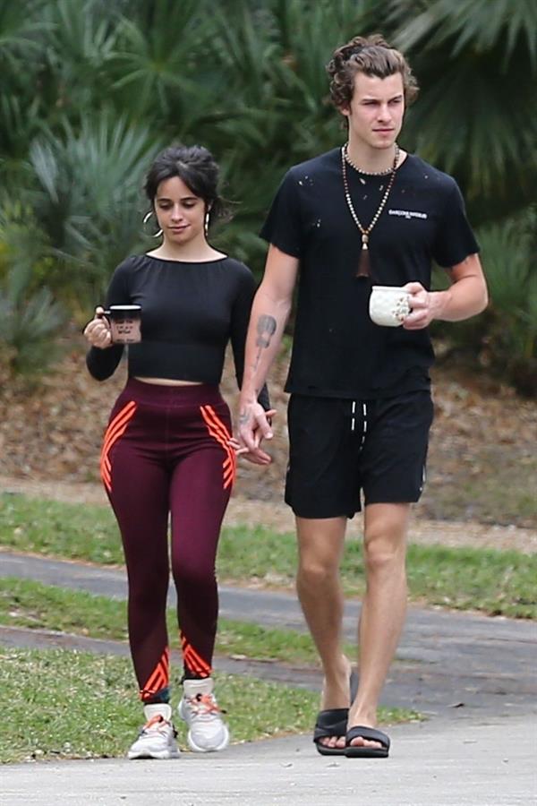 Camila Cabello and Shawn Mendes out walking holding hands with Camila going braless showing off her tits and sexy ass in workout wear seen by paparazzi.
