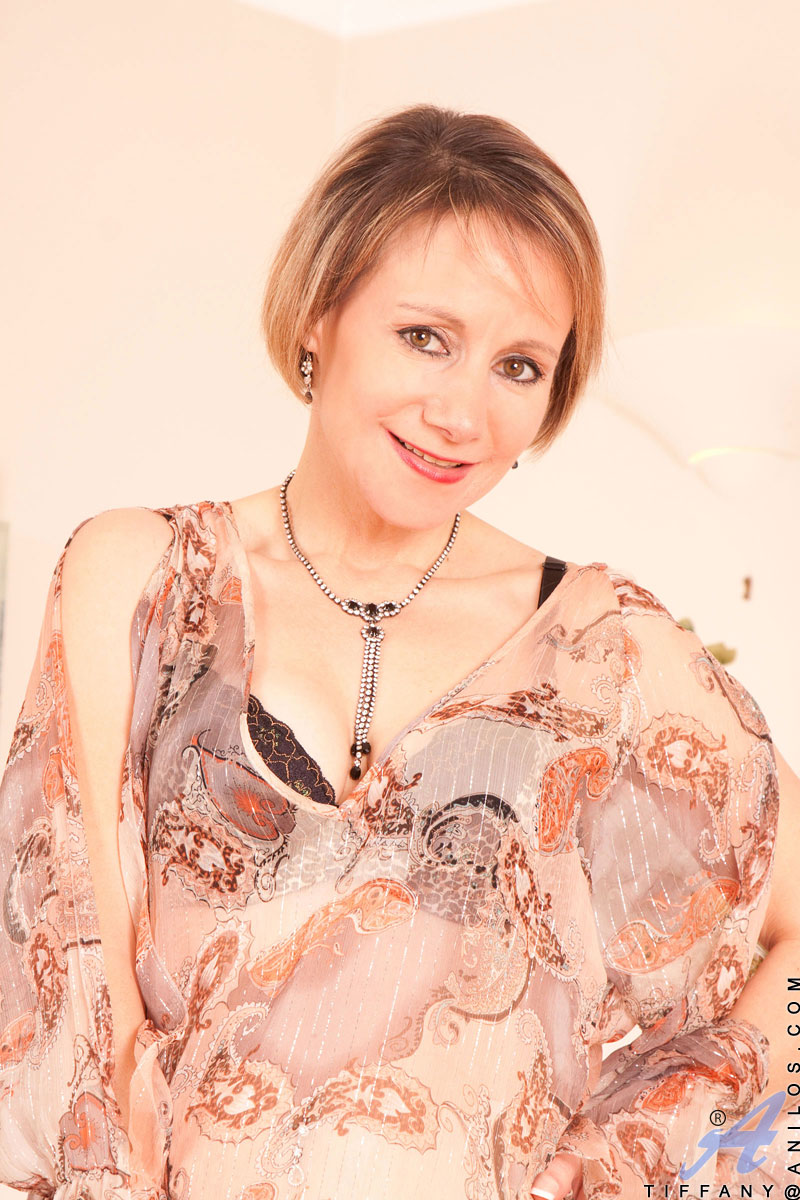 Naughty cougar from next door poses in her bra and sheer panties