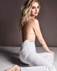 Chiara Ferragni topless new photo from her latest photoshoot wearing just sexy white pants showing off her tattoo and her arm covering her nude boobs.
