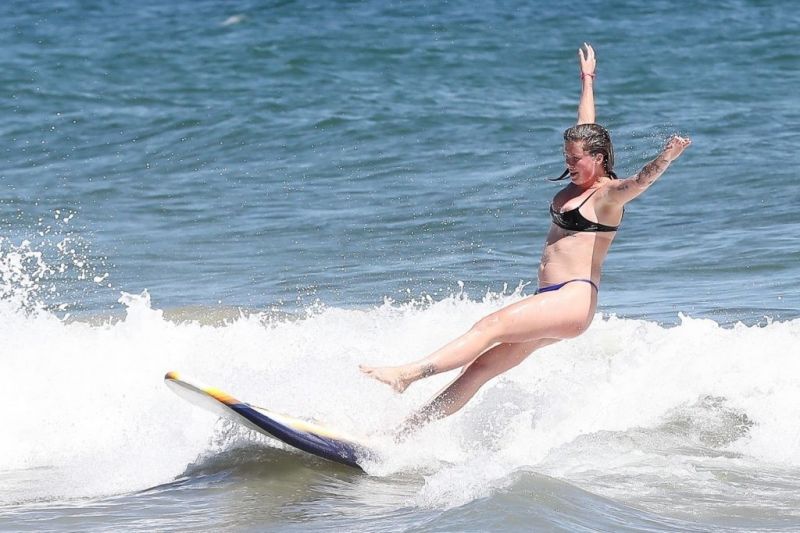 Ireland Baldwin nip slip wardrobe malfunction accidentally flashing her nude big tits falling off a surf board also showing off her ass in a thong bikini.