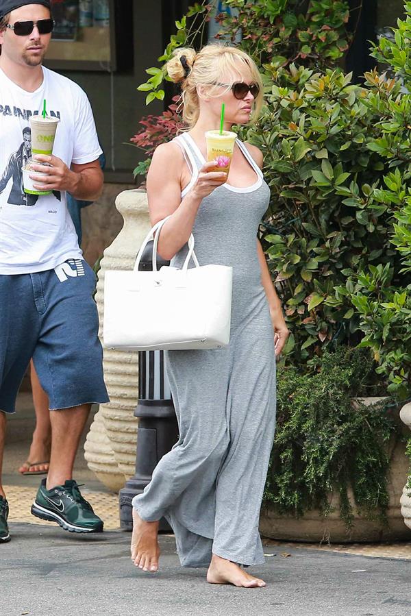 Pamela Anderson leaves barefoot a local Restaurant with a friend in Malibu July 6, 2013 