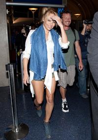 Pamela Anderson shows some legs at Los Angeles International Airport on February 20, 2013